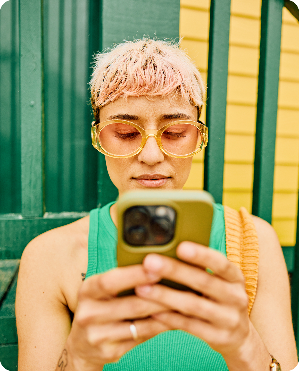 Creator using her phone in a bright, colorful setting