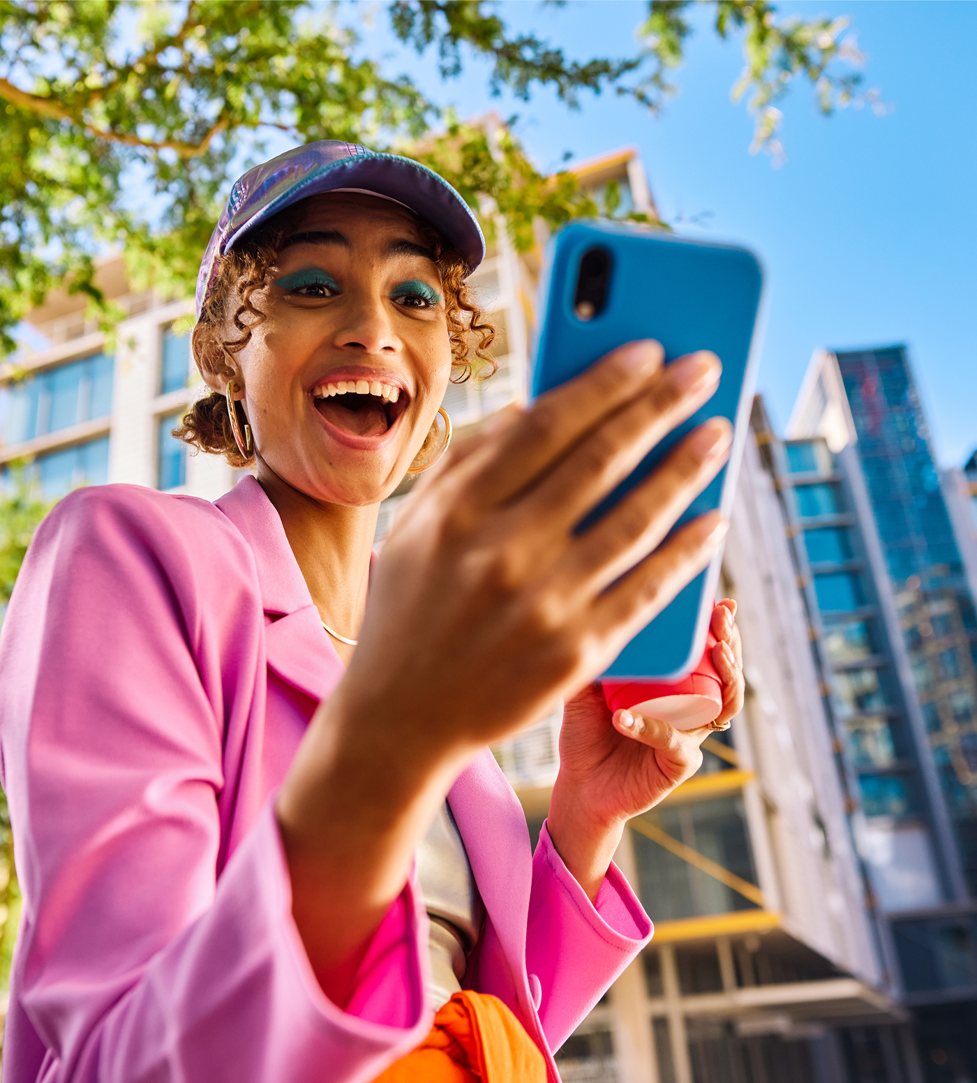 Creator smiling while looking at her phone